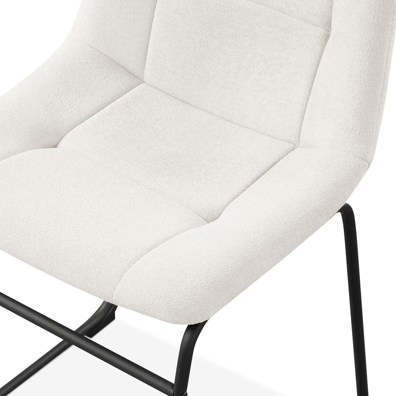 Left facing close up single view of a set of two contemporary white chenille dining side chairs with black bases on white background