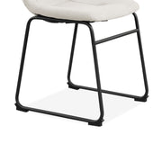 Right facing close up single view of the base on a set of two contemporary white chenille dining side chairs with black bases on a white background