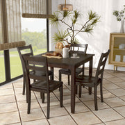Side facing five-piece traditional espresso wooden dining set with a table and four chairs in a room with accessories