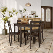 Side facing five-piece traditional espresso wooden dining set with a table and four chairs in a room with accessories