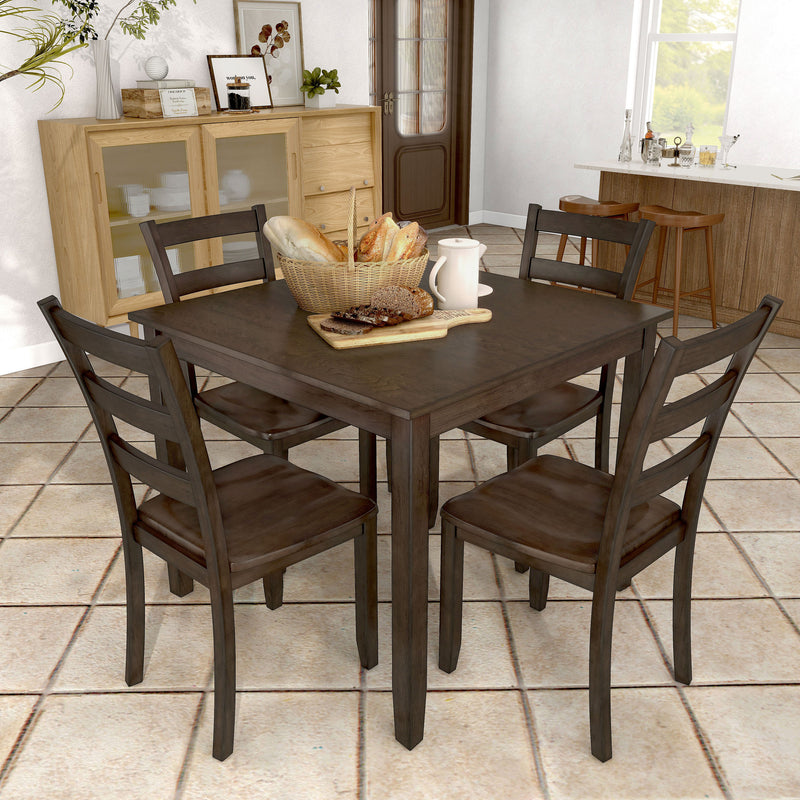 Side facing five-piece traditional espresso wooden dining set with a table and four chairs in a room with accessories