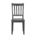 Front facing chair-only view of five-piece traditional grey wooden dining set with a table and four chairs on a white background