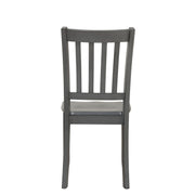 Front facing chair-only back view of five-piece traditional grey wooden dining set with a table and four chairs on a white background