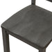 Left-facing close up of the contoured seat of the side chair featured in a five-piece traditional grey wooden dining set with a table and four chairs on a white background