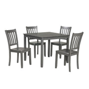 Side facing five-piece traditional grey wooden dining set with a table and four chairs on a white background