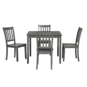 Front facing five-piece traditional grey wooden dining set with a table and four chairs on a white background