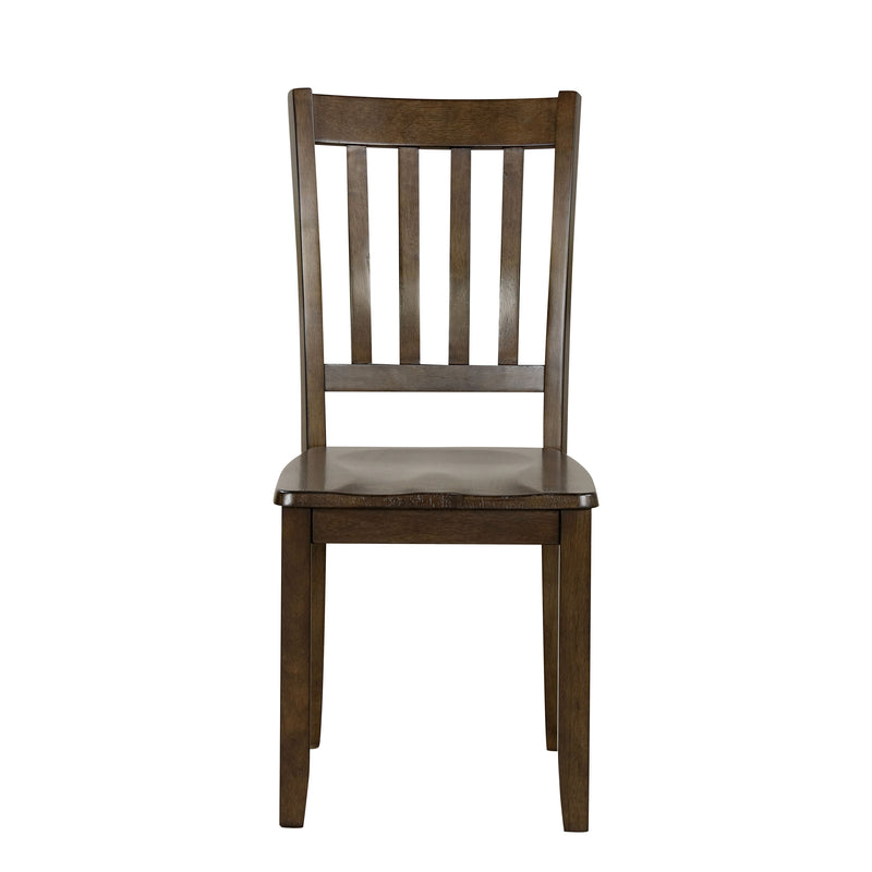 Front facing chair-only view of five-piece traditional walnut wooden dining set with a table and four chairs on a white background
