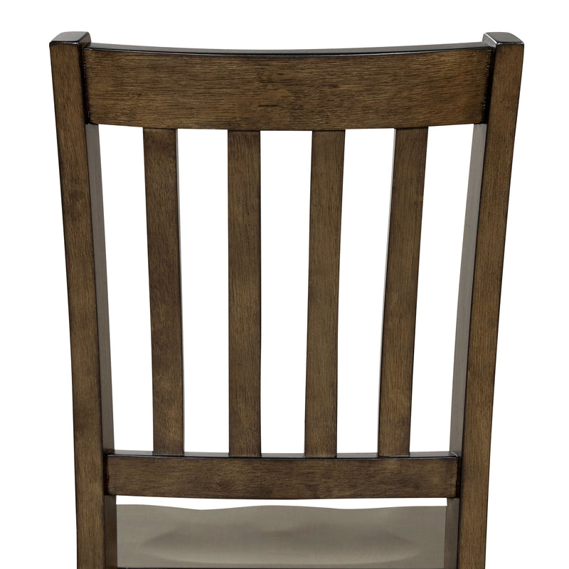 Front-facing close up of the slatted back of the side chair featured in a five-piece traditional walnut wooden dining set with a table and four chairs on a white background