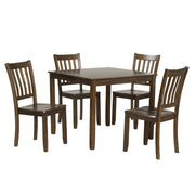 Side facing five-piece traditional walnut wooden dining set with a table and four chairs on a white background