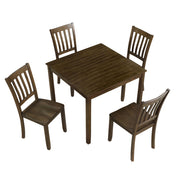 Side facing high-camera view of a five-piece traditional walnut wooden dining set with a table and four chairs on a white background