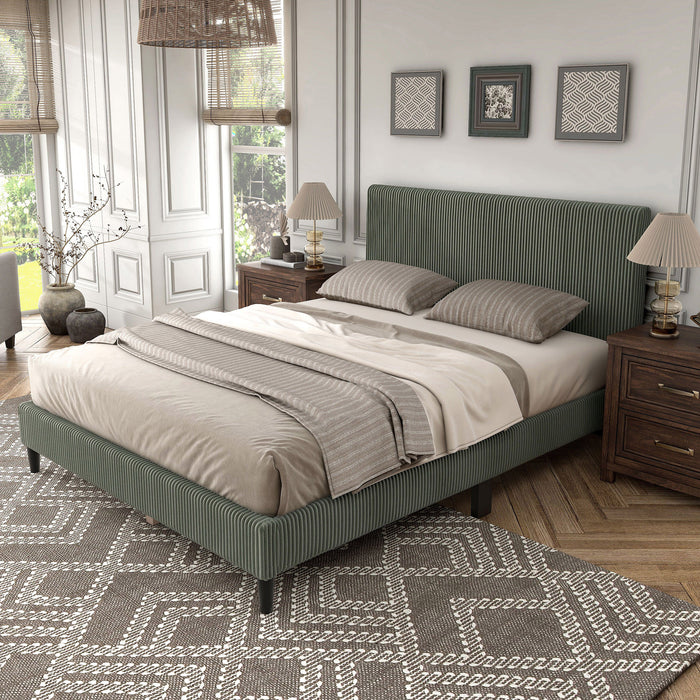Left facing modern green corduroy channel tufted headboard queen platform bed in a room with linens and accessories