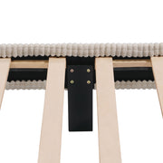 Front facing close up view of the interior support leg of a modern ivory corduroy channel tufted headboard queen platform bed on a white background