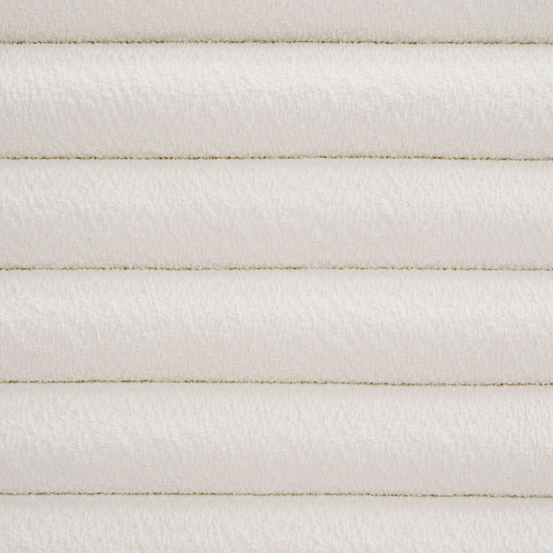 Front facing close up headboard view of a modern wood frame queen platform bed with a channel tufted upholstered white boucle headboard