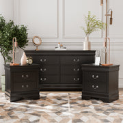 Three-piece traditional black finish bedroom set that includes (1) five-drawer chest and (2) two-drawer nightstands in a room with accessories