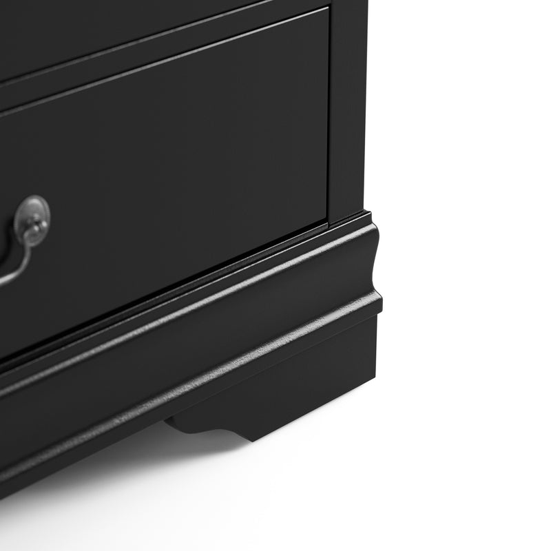 Right facing close up of a traditional black finish solid wood six-drawer dresser showing its lower molded trim and bracket foot, on a white background