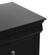 Right facing close up of a traditional black finish solid wood two-drawer nightstand showing its molded trim and tabletop, on a white background