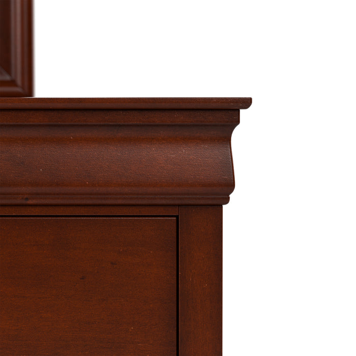 Front facing close up of a traditional cherry finish solid wood six-drawer dresser showing its molded trim, on a white background