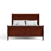 Front facing traditional cherry finish solid wood queen bed with linens on a white background