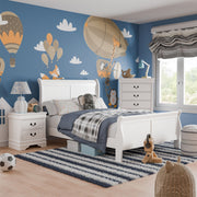 Left facing three-piece traditional black finish solid wood full bedroom set with (1) full sleigh bed, (1) two-drawer nightstand, and (1) five-drawer chest in a room with linens and accessories