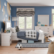 Right facing side view of a four-piece traditional white finish solid wood full bedroom set with (1) full sleigh bed, (1) two-drawer nightstand, (1) six-drawer dresser, and (1) mirror in a room with linens and accessories