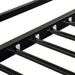 Close up view of the slats of a contemporary black metal twin-over-full bunk bed on a white background