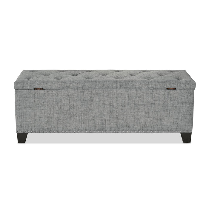 Front facing back view of a modern grey upholstered storage bench with a lift top on a white background