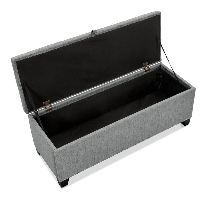 Right facing bird's eye view of a modern grey upholstered storage bench with a lift top opened on a white background