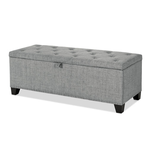 Left facing modern grey upholstered storage bench with a lift top on a white background