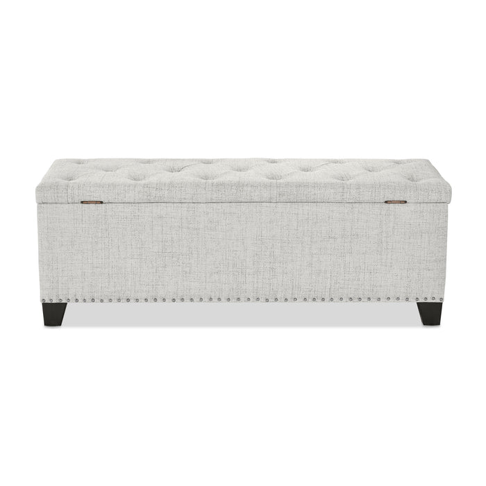 Front facing back view of a modern off white upholstered storage bench with a lift top on a white background