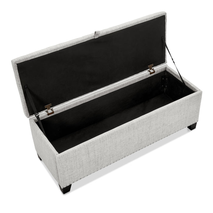 Right facing bird's eye view of a modern off white upholstered storage bench with a lift top opened on a white background