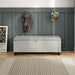 Front facing modern off white upholstered storage bench with a lift top in a room with accessories