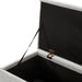 Left facing close up of the open top of a modern off white upholstered storage bench with a lift top in a room with accessories
