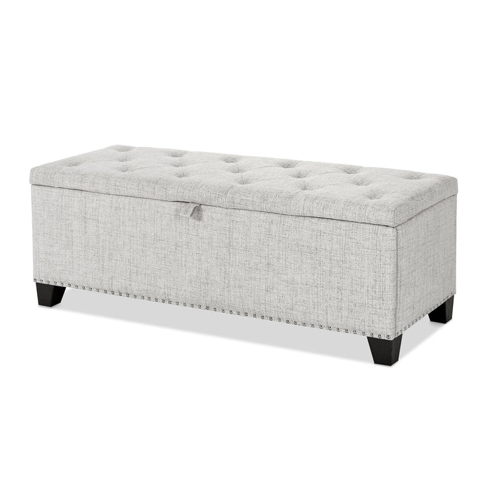 Left facing modern off white upholstered storage bench with a lift top on a white background
