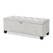 Left facing modern off white upholstered storage bench with a lift top on a white background