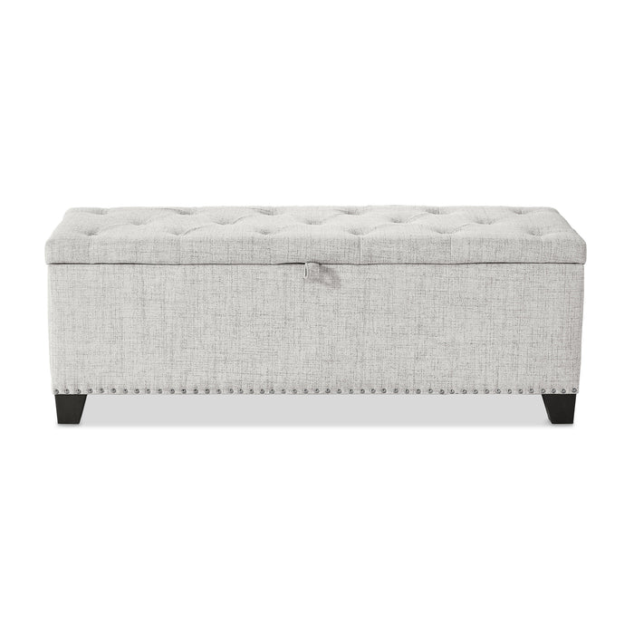 Front facing modern off white upholstered storage bench with a lift top on a white background