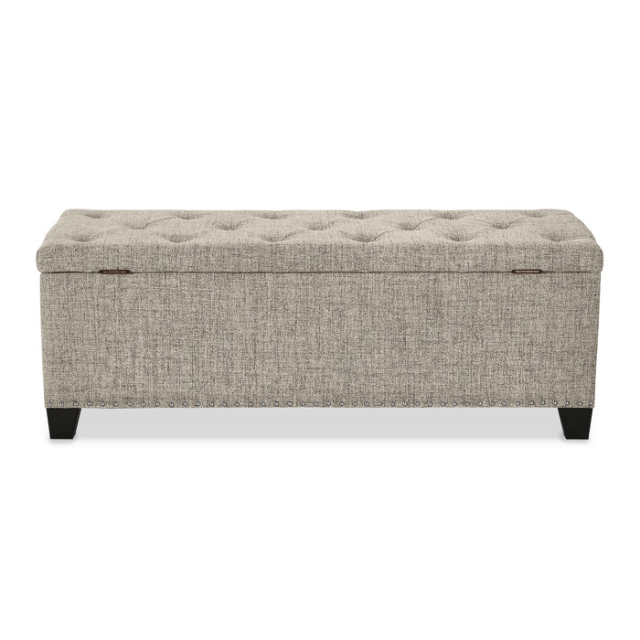 Front facing back view of a modern light brown upholstered storage bench with a lift top on a white background