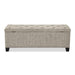 Front facing back view of a modern light brown upholstered storage bench with a lift top on a white background