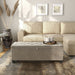 Front facing modern light brown upholstered storage bench with a lift top in a room with accessories