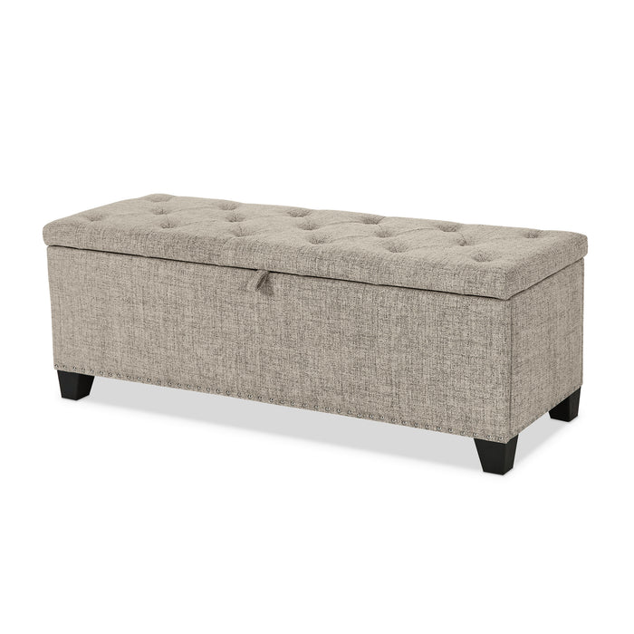 Left facing modern light brown upholstered storage bench with a lift top on a white background