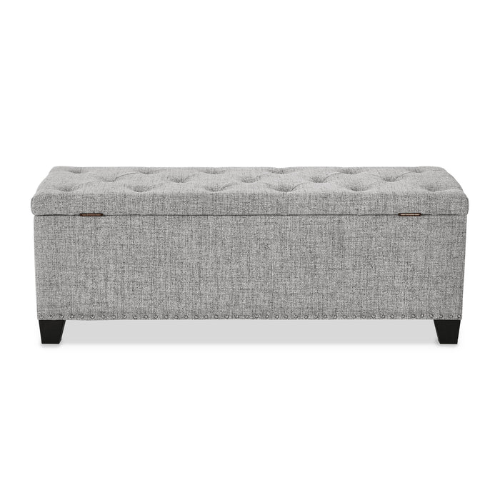 Front facing back view of a modern light grey upholstered storage bench with a lift top on a white background
