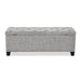 Front facing back view of a modern light grey upholstered storage bench with a lift top on a white background