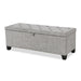 Left facing modern light grey upholstered storage bench with a lift top on a white background