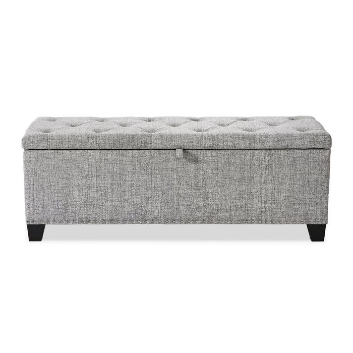 Front facing modern light grey upholstered storage bench with a lift top on a white background