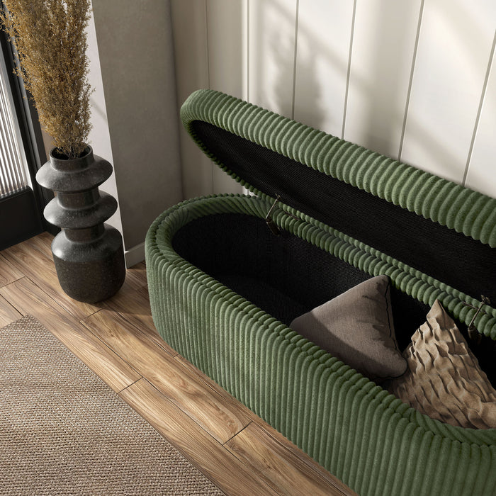 Left facing modern tufted green chenille oval storage bench with top open in a room with accessories