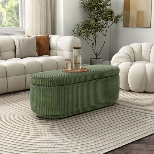 Right facing modern tufted green chenille oval storage bench in a room with accessories