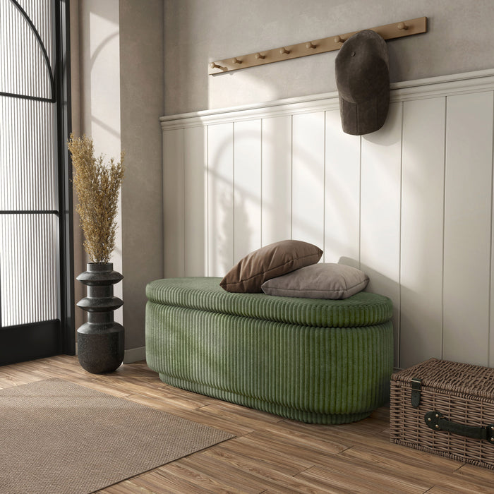 Left facing modern tufted green chenille oval storage bench in a room with accessories
