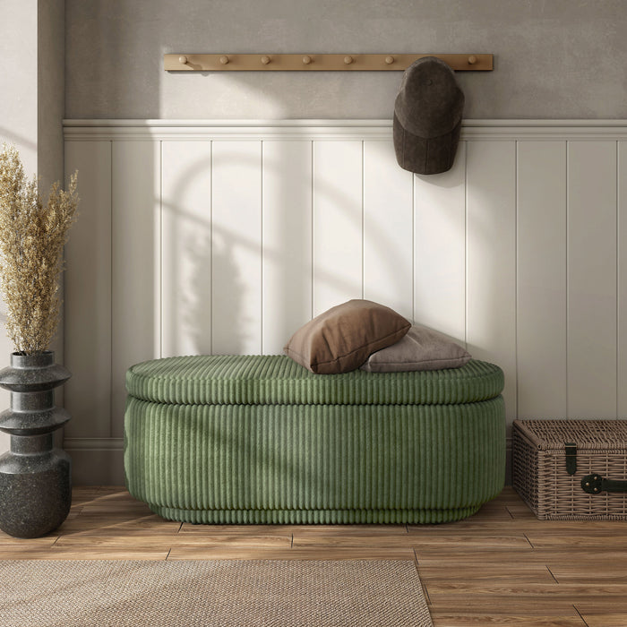 Front facing modern tufted green chenille oval storage bench in a room with accessories