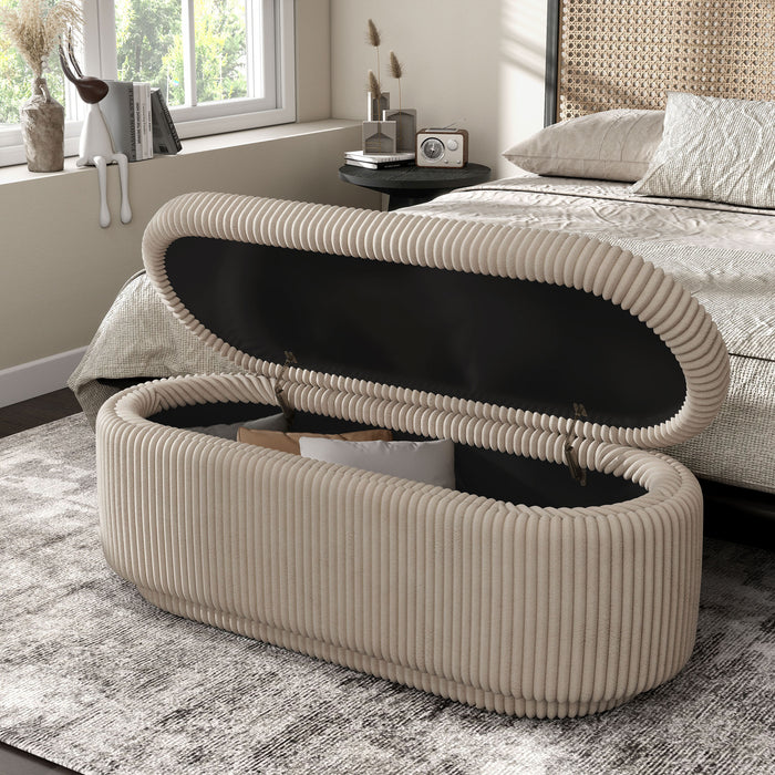Left facing modern tufted beige pink chenille oval storage bench with top open in a room with accessories