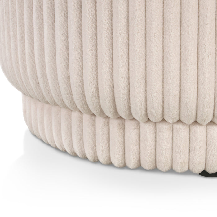 Right facing close up of a modern tufted beige pink chenille oval storage bench on a white background
