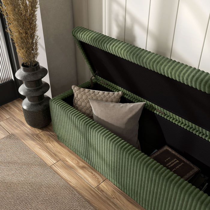 Left facing modern tufted green chenille rectangular storage bench with top open in a room with accessories